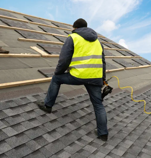 Burroughs Roofing has experienced roof installers like the one shown in this picture adding a new roof to a home.